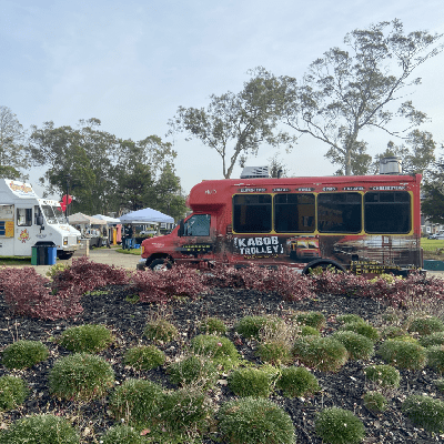 a bus traveling on a train track with trees in the background