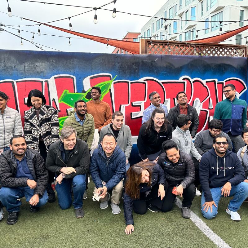 a group of people standing in front of a crowd posing for the camera