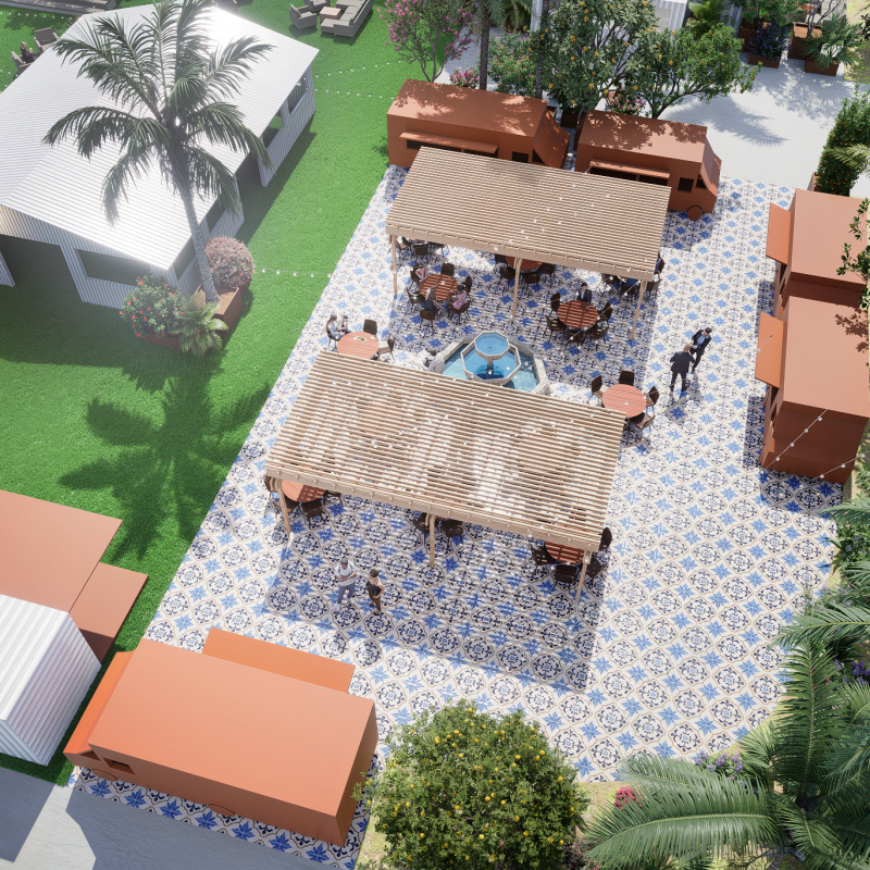 Aerial view of a tiled patio with pergolas, tables, and people, surrounded by greenery and a white building.