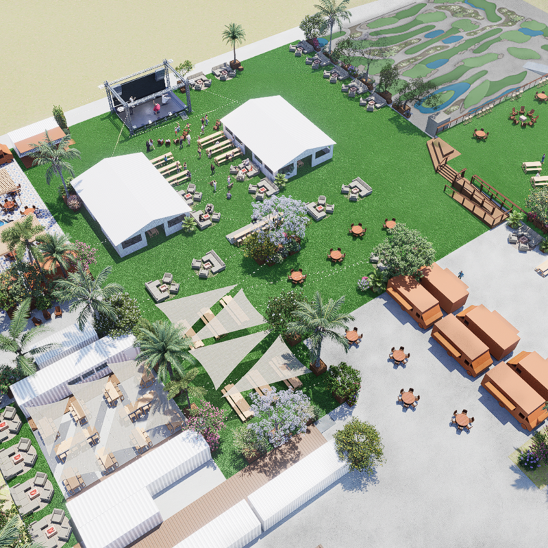 Aerial view of outdoor event space with tents, seating, and a stage on a grassy area.